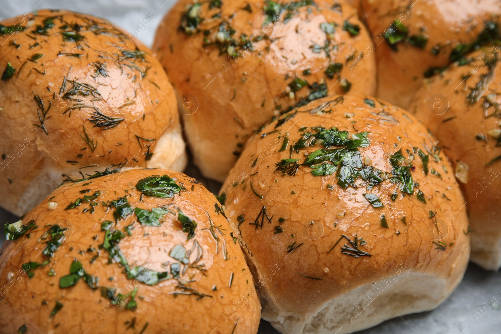 Photo of Traditional pampushka buns with garlic and herbs, closeup