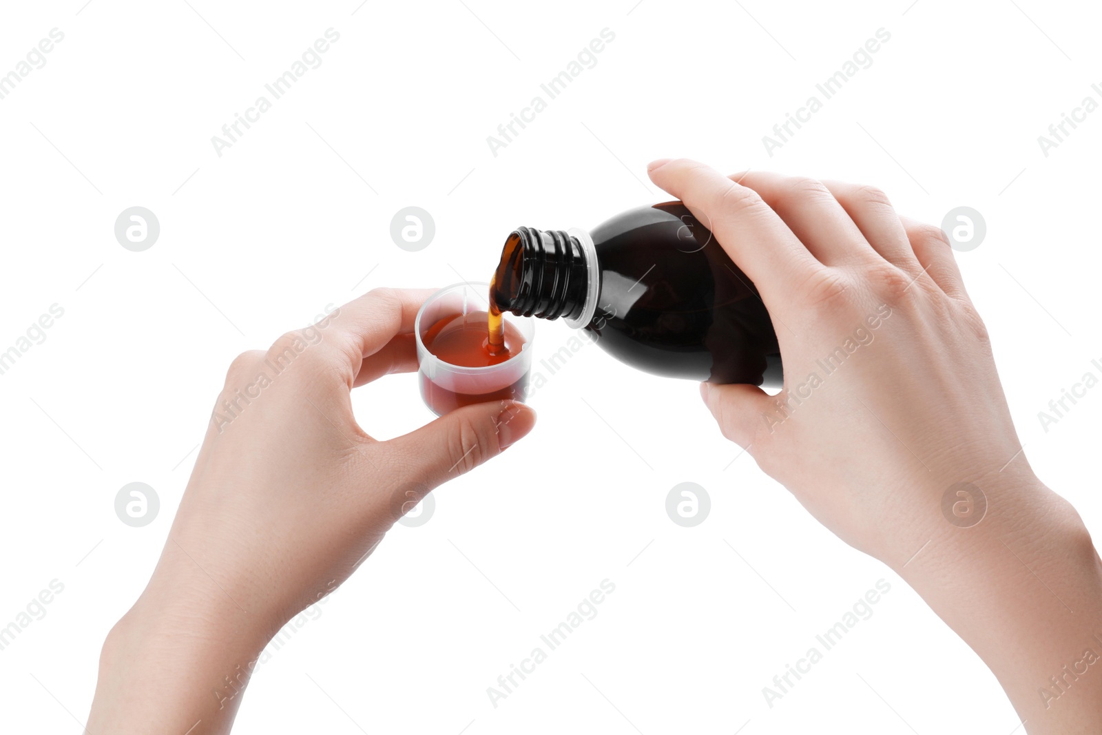 Photo of Woman pouring syrup into measuring cup from bottle isolated on white, closeup. Cough and cold medicine