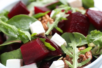 Delicious beet salad with feta cheese in bowl, closeup