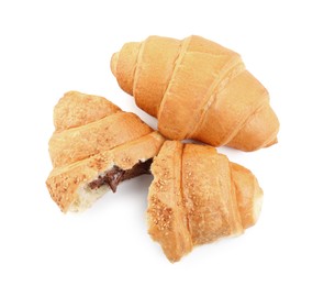 Photo of Tasty croissants with chocolate on white background, top view