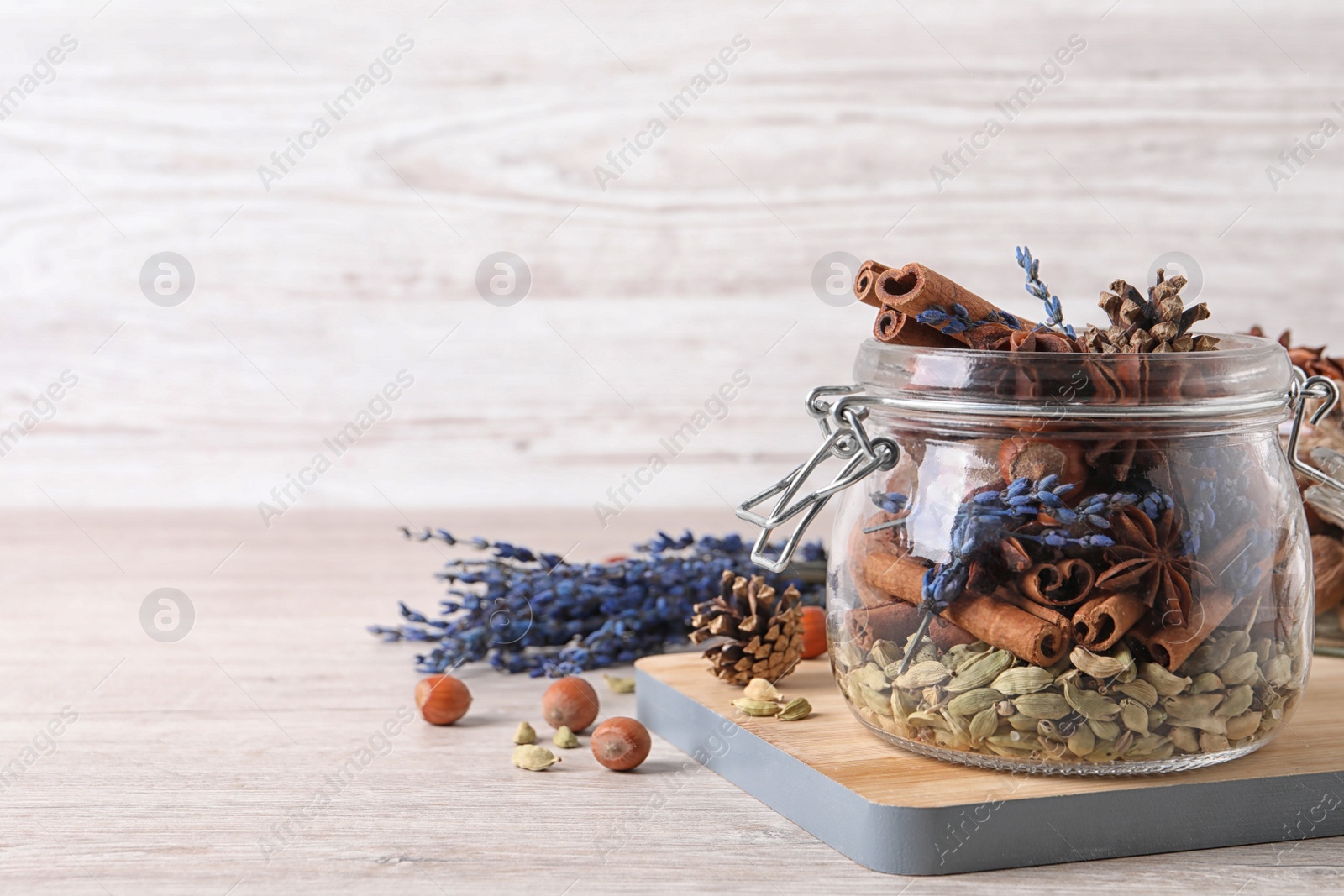 Photo of Aroma potpourri with different spices on white wooden table, space for text