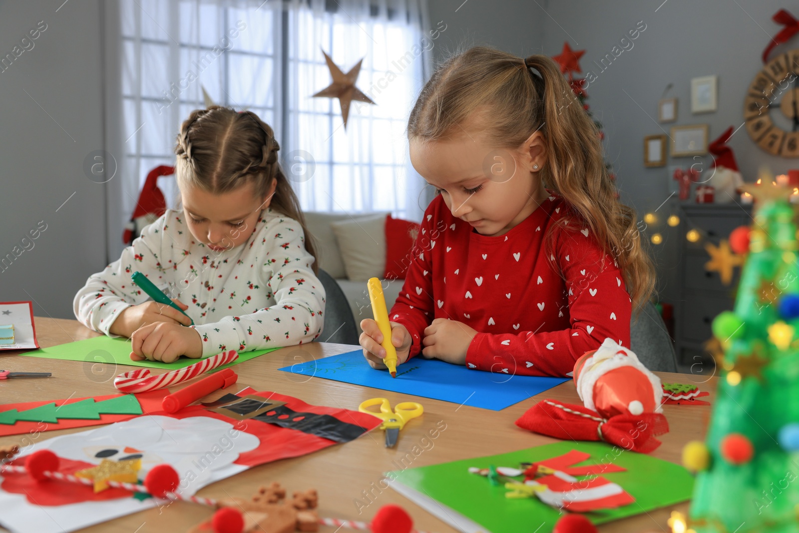 Photo of Cute little children making beautiful Christmas greeting cards at home