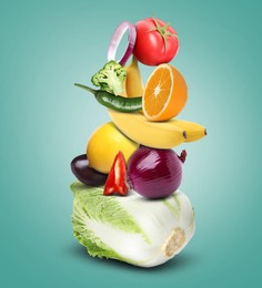Image of Stack of different vegetables and fruits on light sea green background