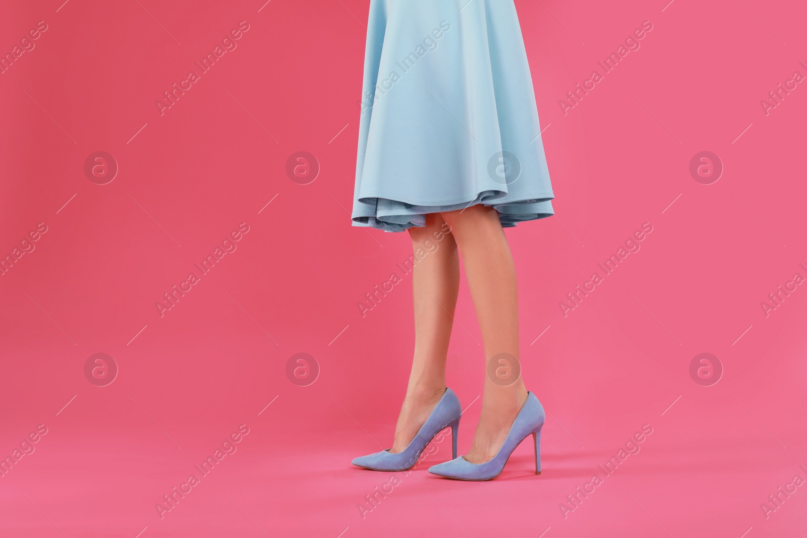 Photo of Woman in elegant shoes on pink background