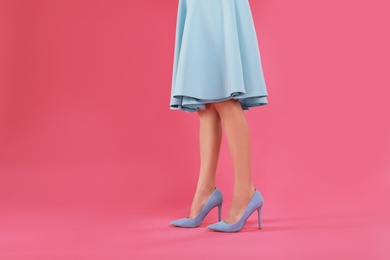 Photo of Woman in elegant shoes on pink background