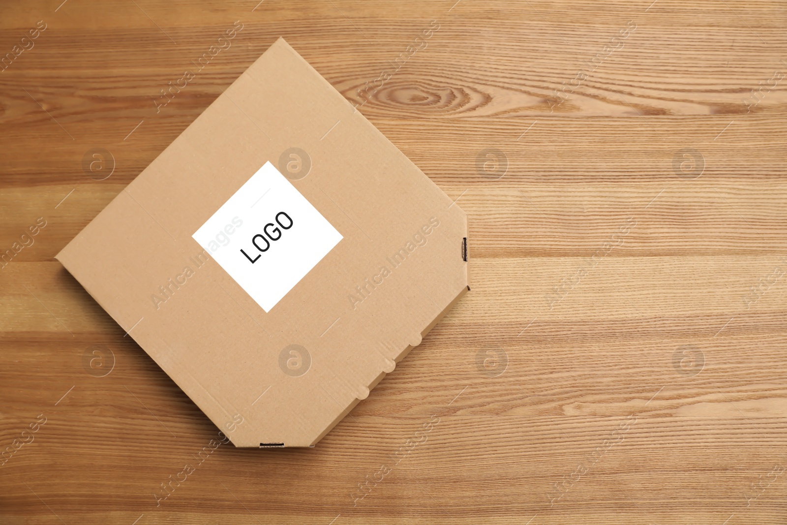 Image of Cardboard pizza box with logo on wooden background, top view