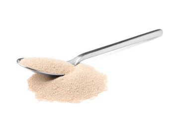 Spoon with granulated yeast on white background
