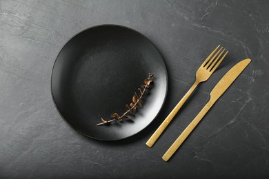 Photo of Stylish setting with elegant cutlery on grey textured table, flat lay