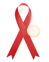 Red ribbon and condom isolated on white, top view. AIDS disease awareness