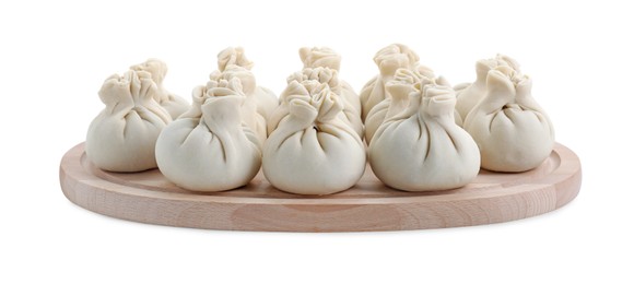 Photo of Wooden board with uncooked khinkali (dumplings) isolated on white. Georgian cuisine