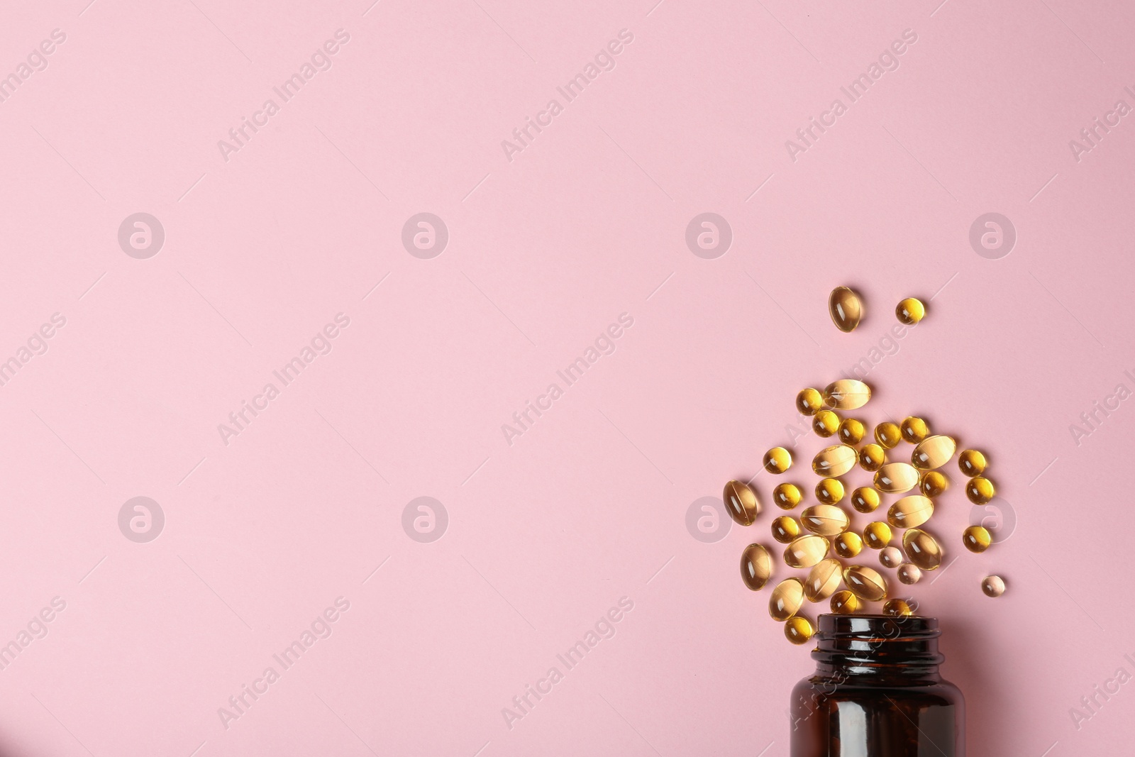 Photo of Bottle with cod liver oil capsules on color background, flat lay. Space for text