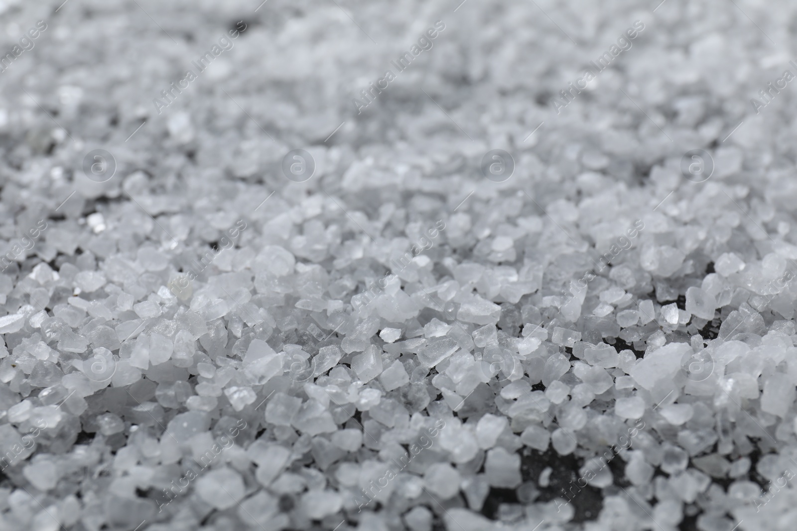 Photo of White natural salt as background, closeup view