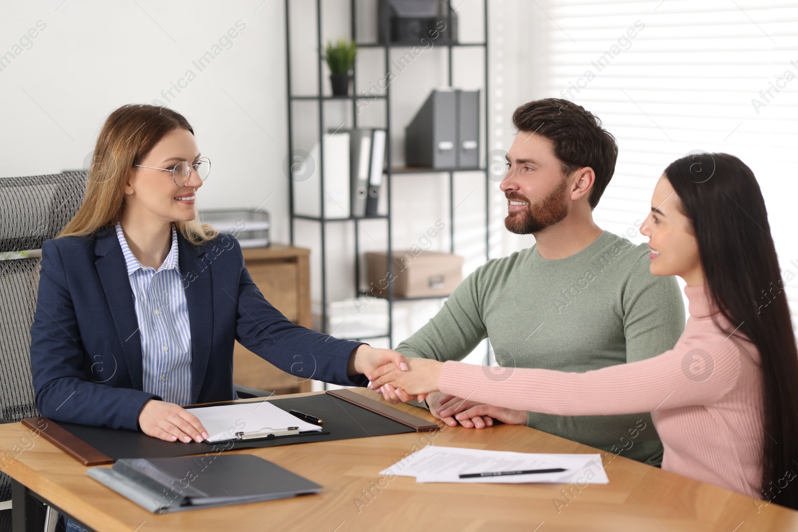 Photo of Lawyer shaking hands with clients in office