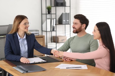 Photo of Lawyer shaking hands with clients in office