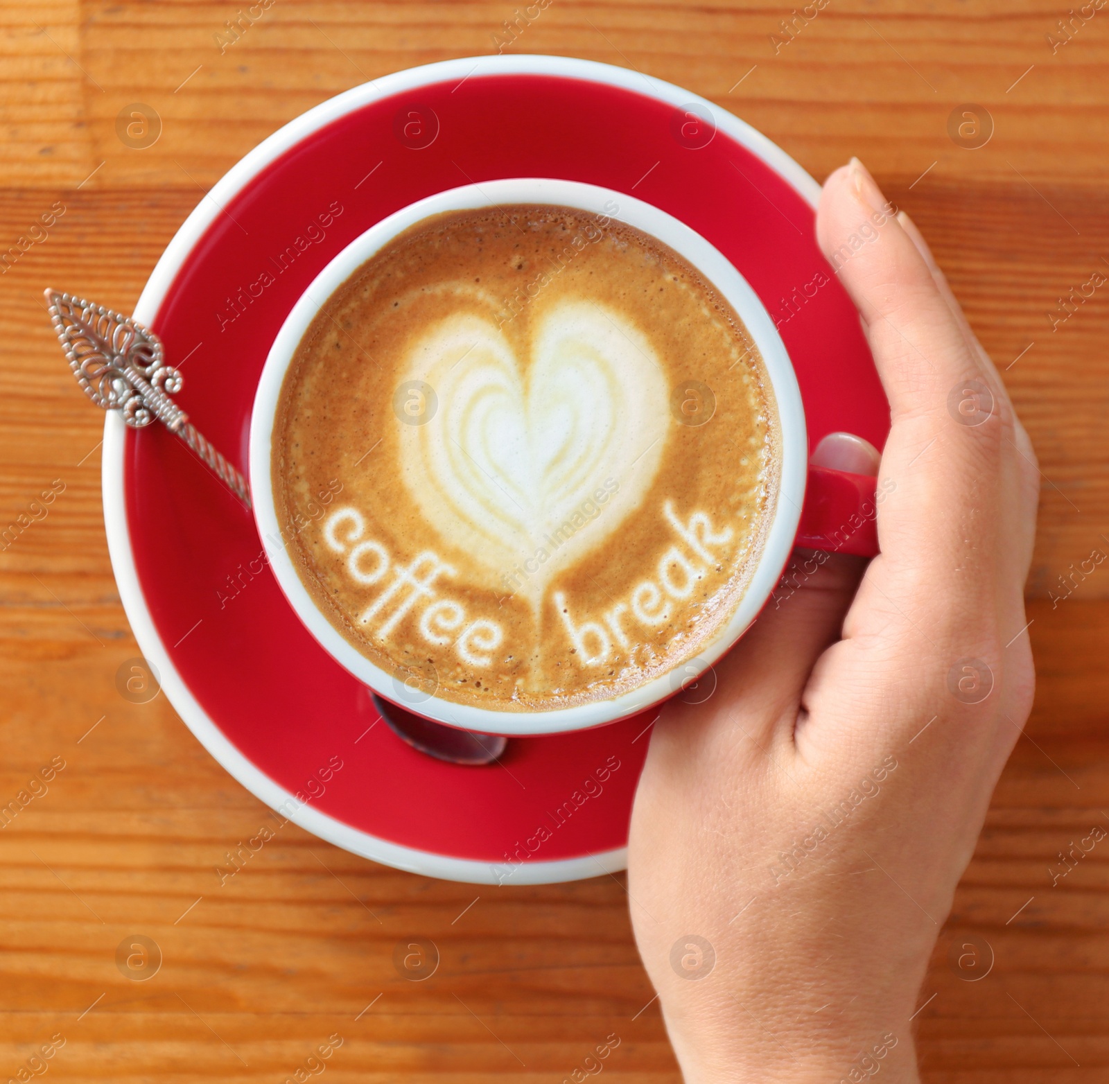 Image of Coffee Break. Woman with cup of cappuccino at  wooden table, top view