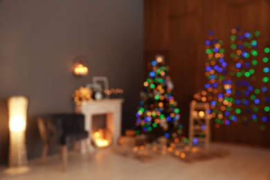 Photo of Blurred stylish room interior with Christmas tree and decorative fireplace