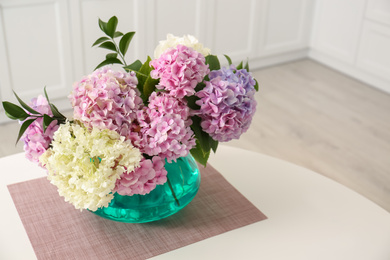 Photo of Bouquet of beautiful hydrangea flowers on table indoors, space for text. Interior design