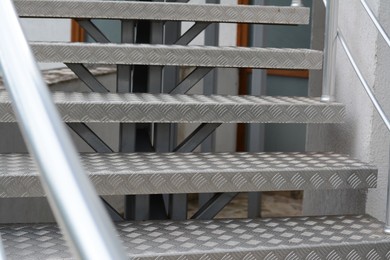 Photo of View of beautiful metal stairs with railing outdoors, closeup