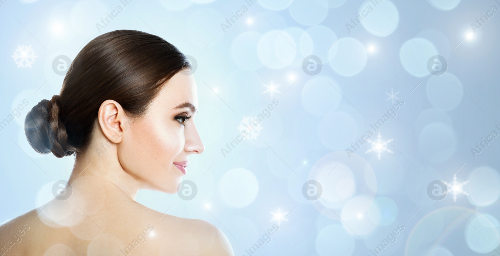 Image of Young woman with perfect smooth skin on light blue background, bokeh effect. Space for text