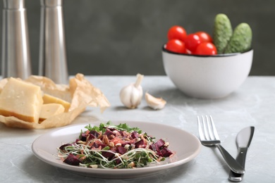 Photo of Delicious carrot salad served on grey table