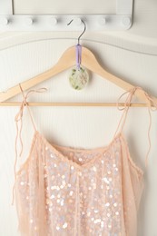 Photo of Scented sachet with flowers and stylish clothes on hanger