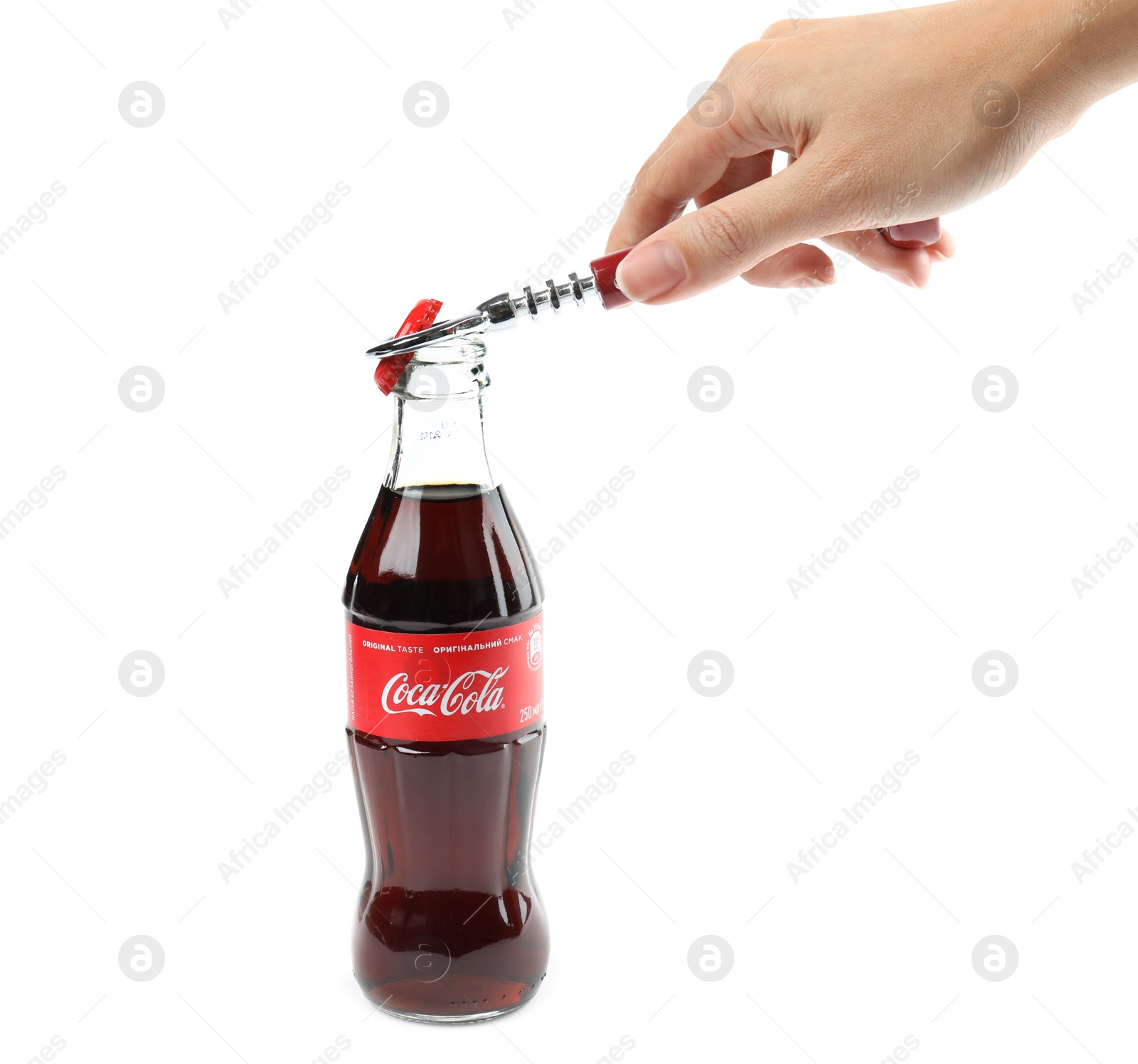 Photo of MYKOLAIV, UKRAINE - NOVEMBER 15, 2018: Woman opening Coca Cola bottle on white background, closeup