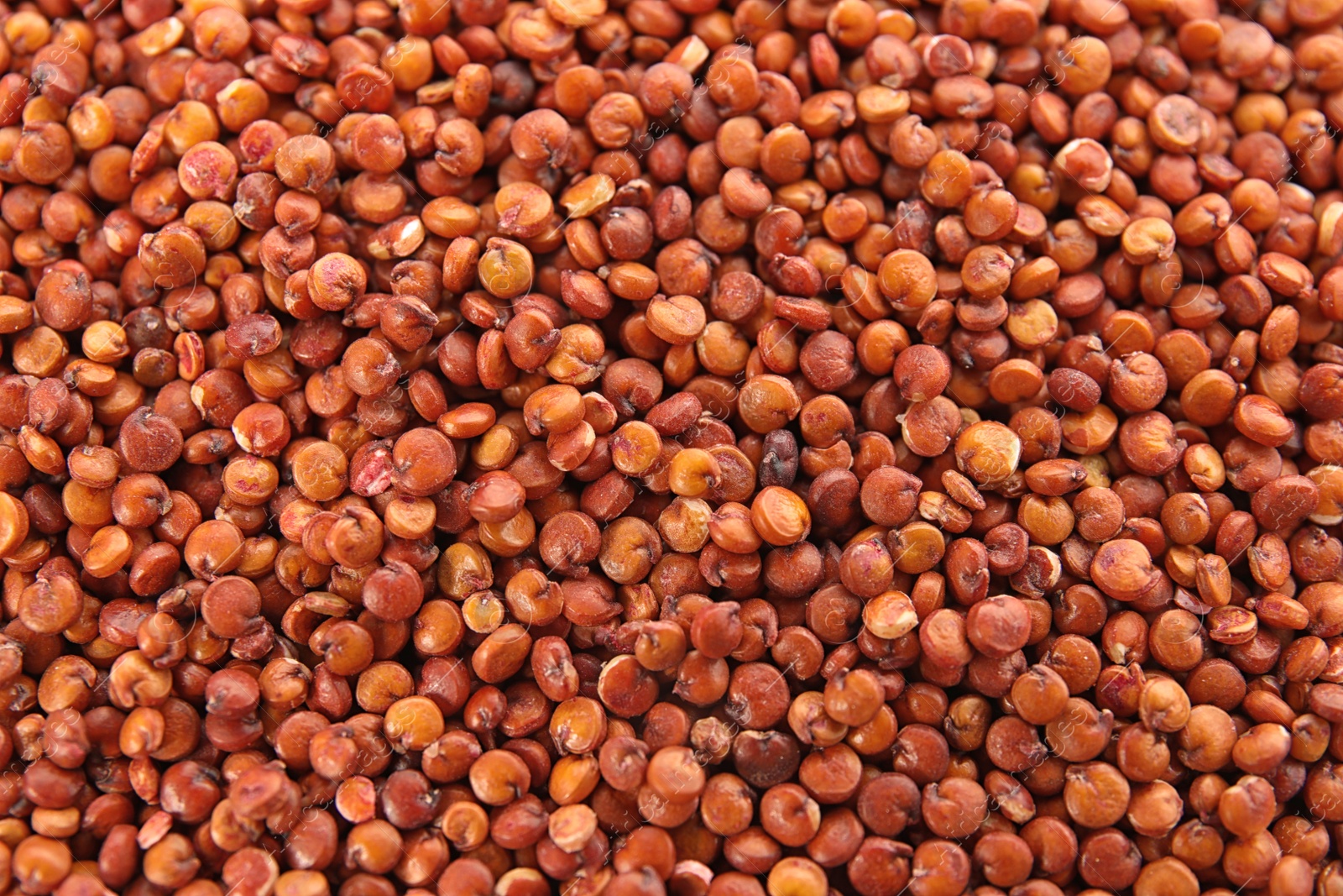 Photo of Raw red quinoa seeds as background, closeup