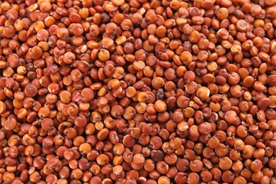 Raw red quinoa seeds as background, closeup