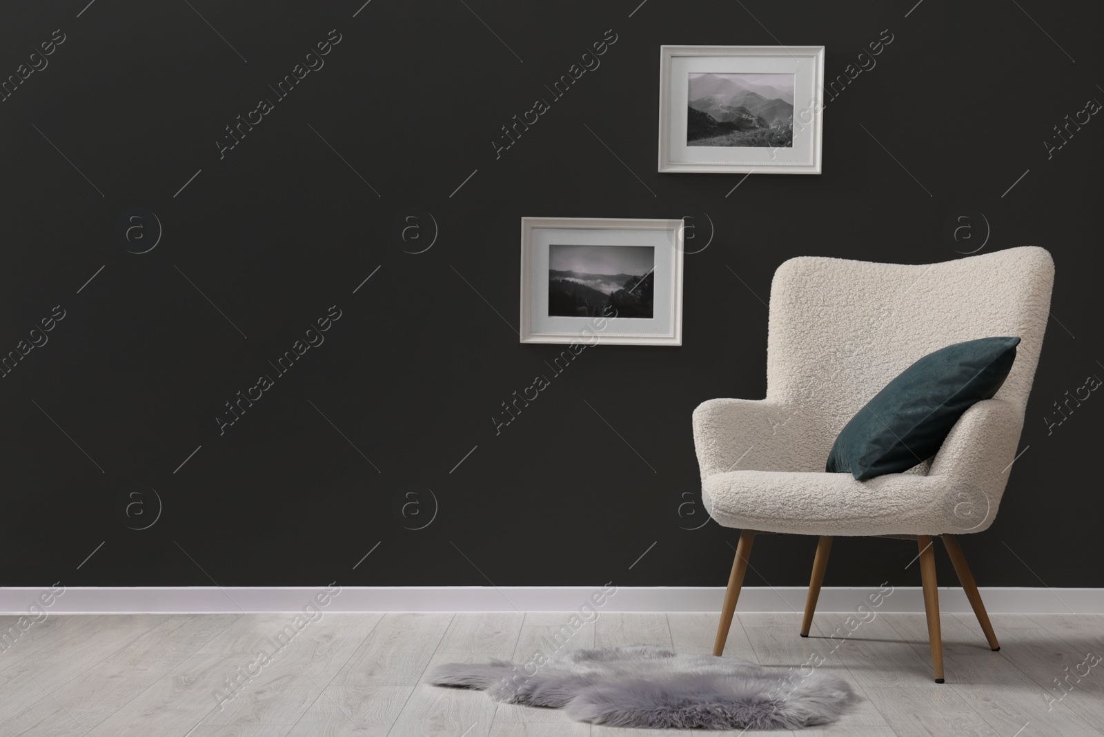 Photo of Stylish interior with comfortable armchair and rug on floor indoors, space for text