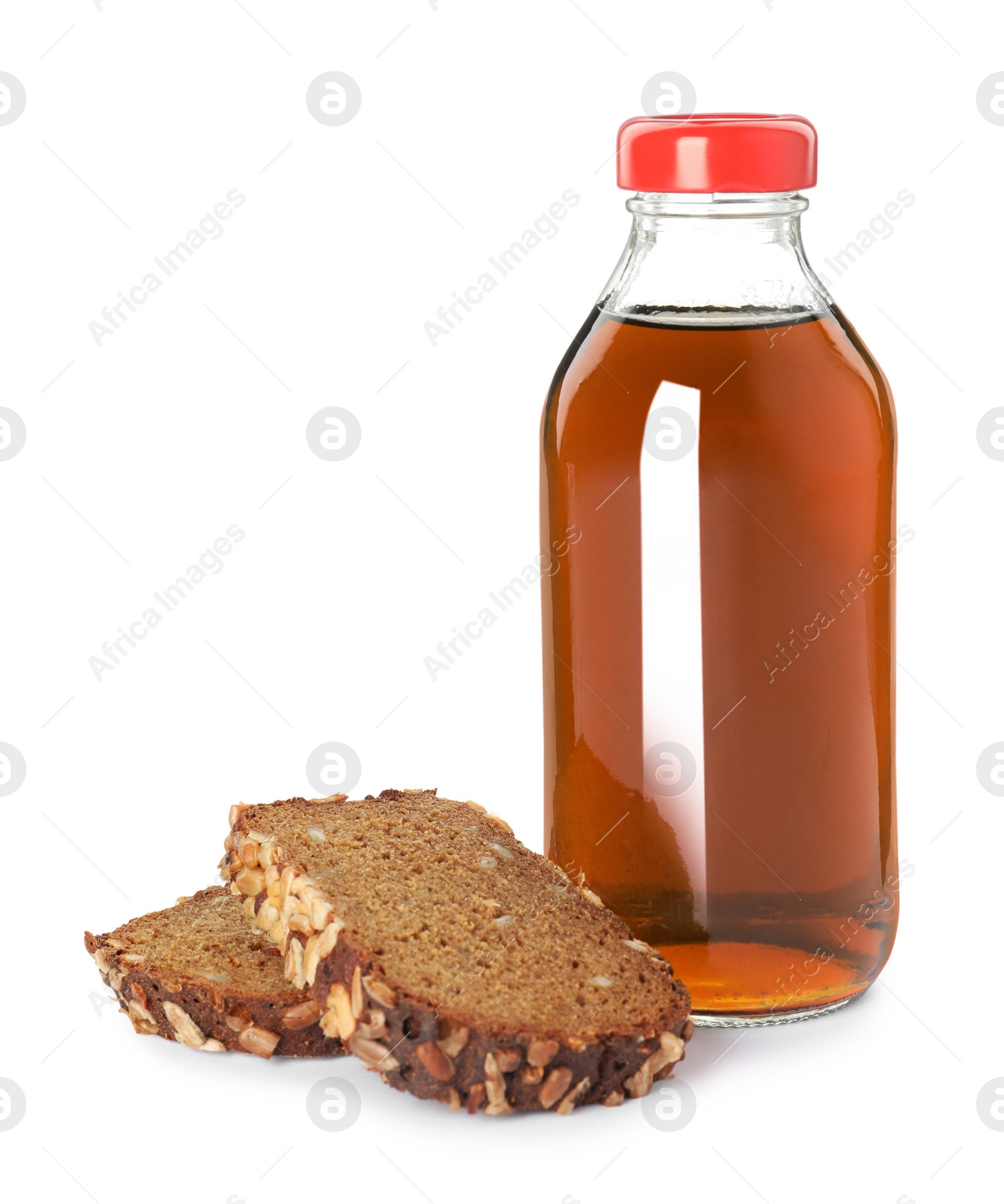 Photo of Glass bottle of delicious kvass and bread slices on white background. Refreshing drink