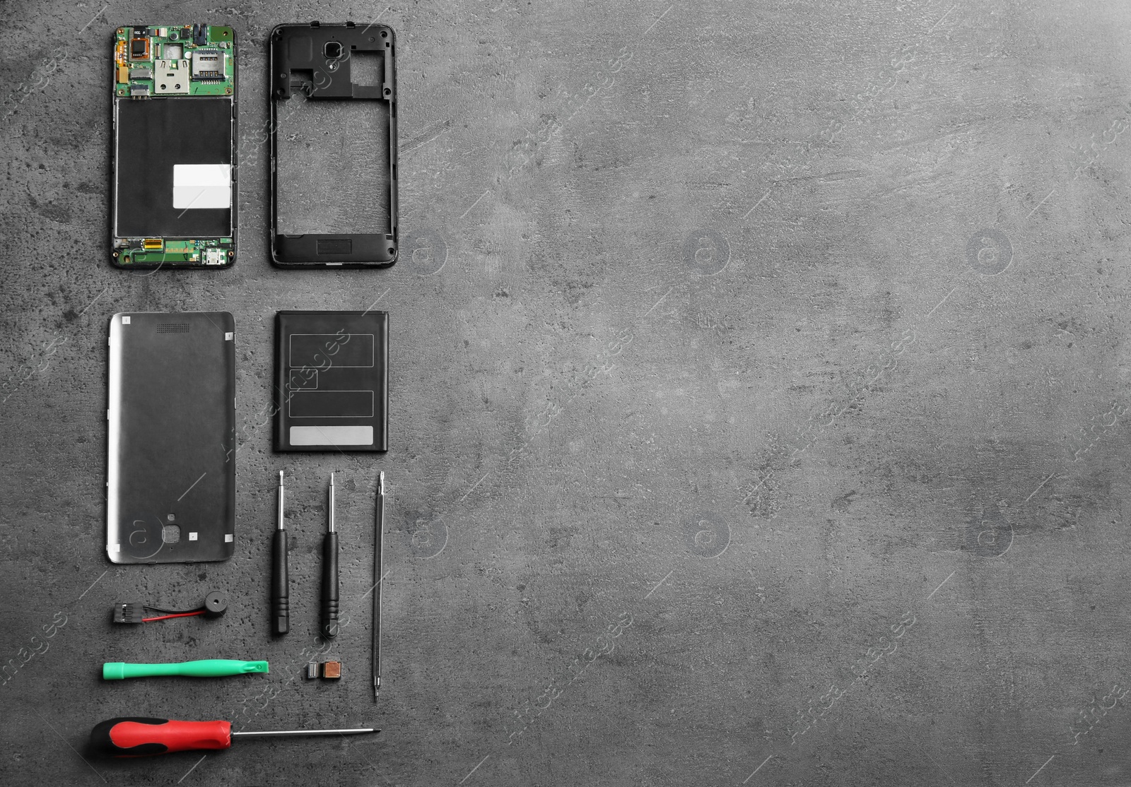 Photo of Disassembled mobile phone and repair tools on table, flat lay. Space for text