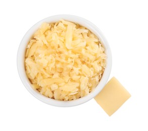 Photo of Grated cheese in bowl and piece of one isolated on white, top view
