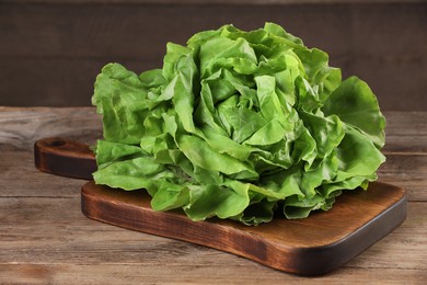 Fresh green butter lettuce on wooden table, closeup