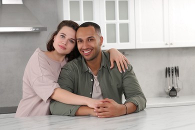 Photo of Dating agency. Woman embracing her boyfriend in kitchen, space for text