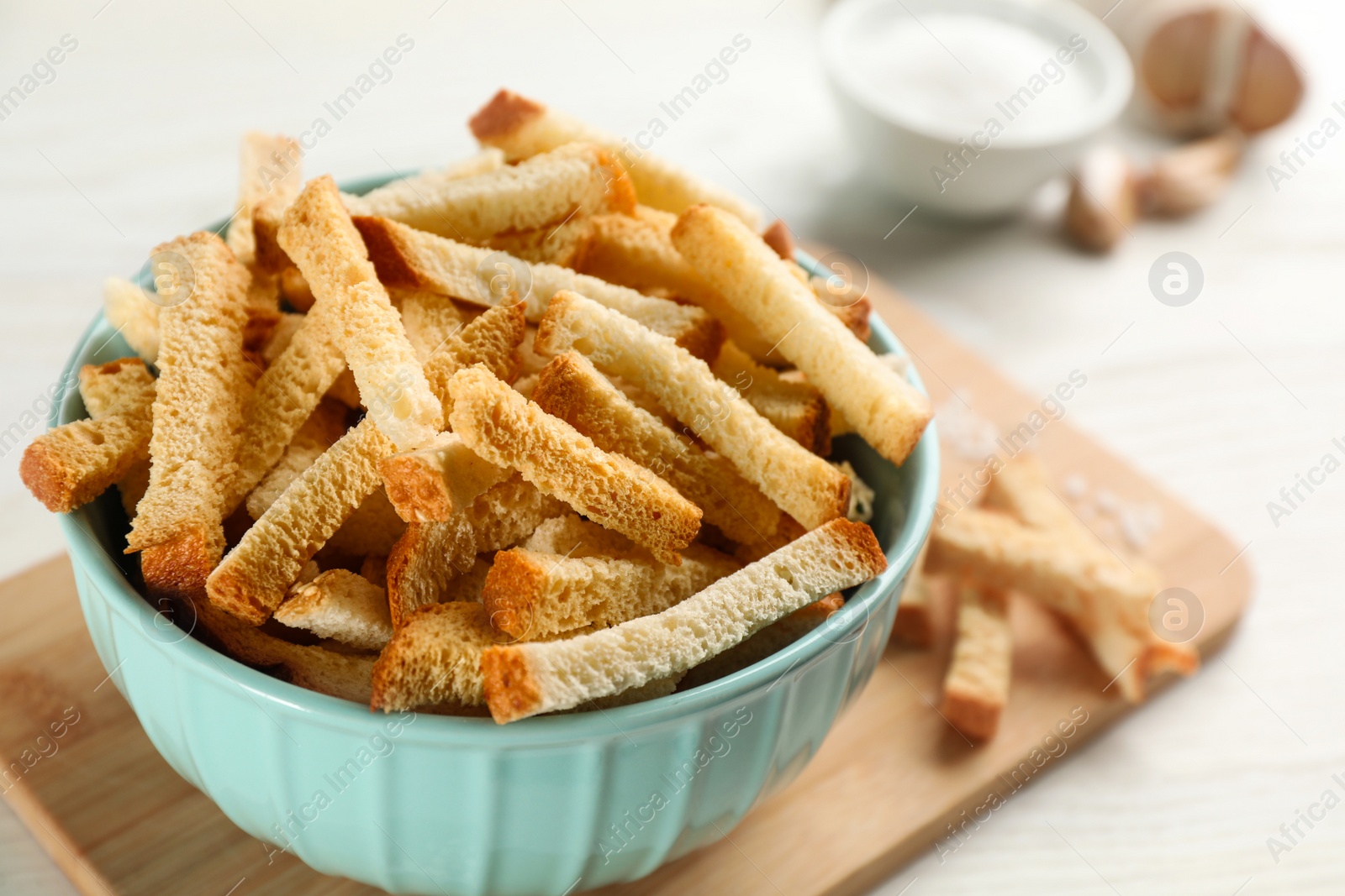 Photo of Delicious hard chucks in bowl on white table, closeup view