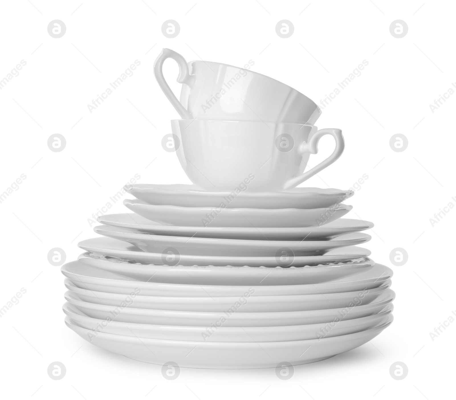 Photo of Stack of clean tableware isolated on white