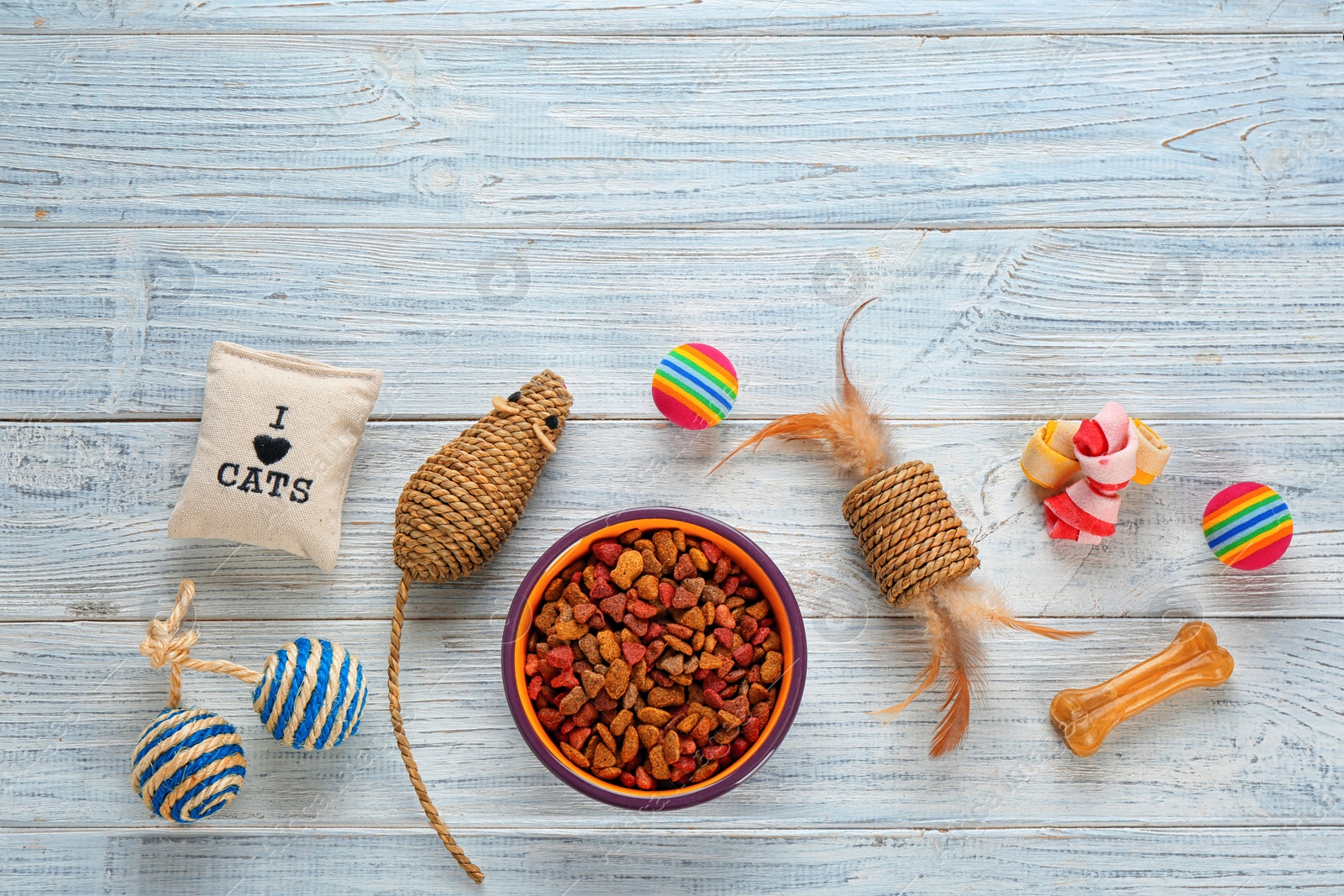 Photo of Cat's accessories and food on wooden background