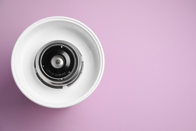 Portable candy cotton machine on violet background, top view. Space for text