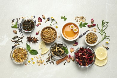 Flat lay composition with fresh brewed tea and dry leaves on light table