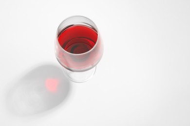 Tasty red wine in glass isolated on white, above view