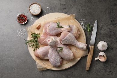Photo of Flat lay composition with fresh raw chicken legs on grey table