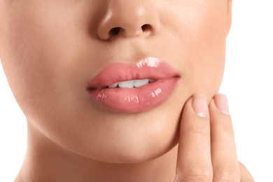 Young woman with beautiful full lips on white background, closeup