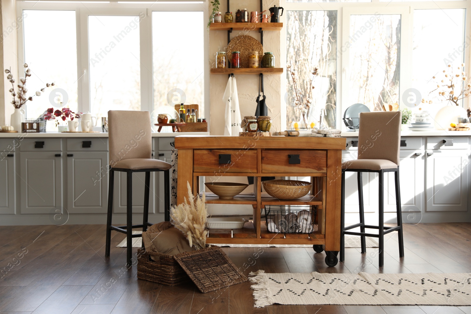 Photo of Stylish kitchen interior with wooden table and chairs