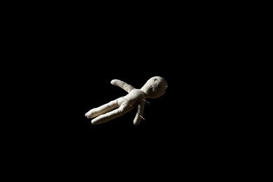 Photo of Voodoo doll with pins on black background