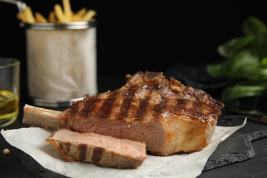 Tasty grilled steak served on black table