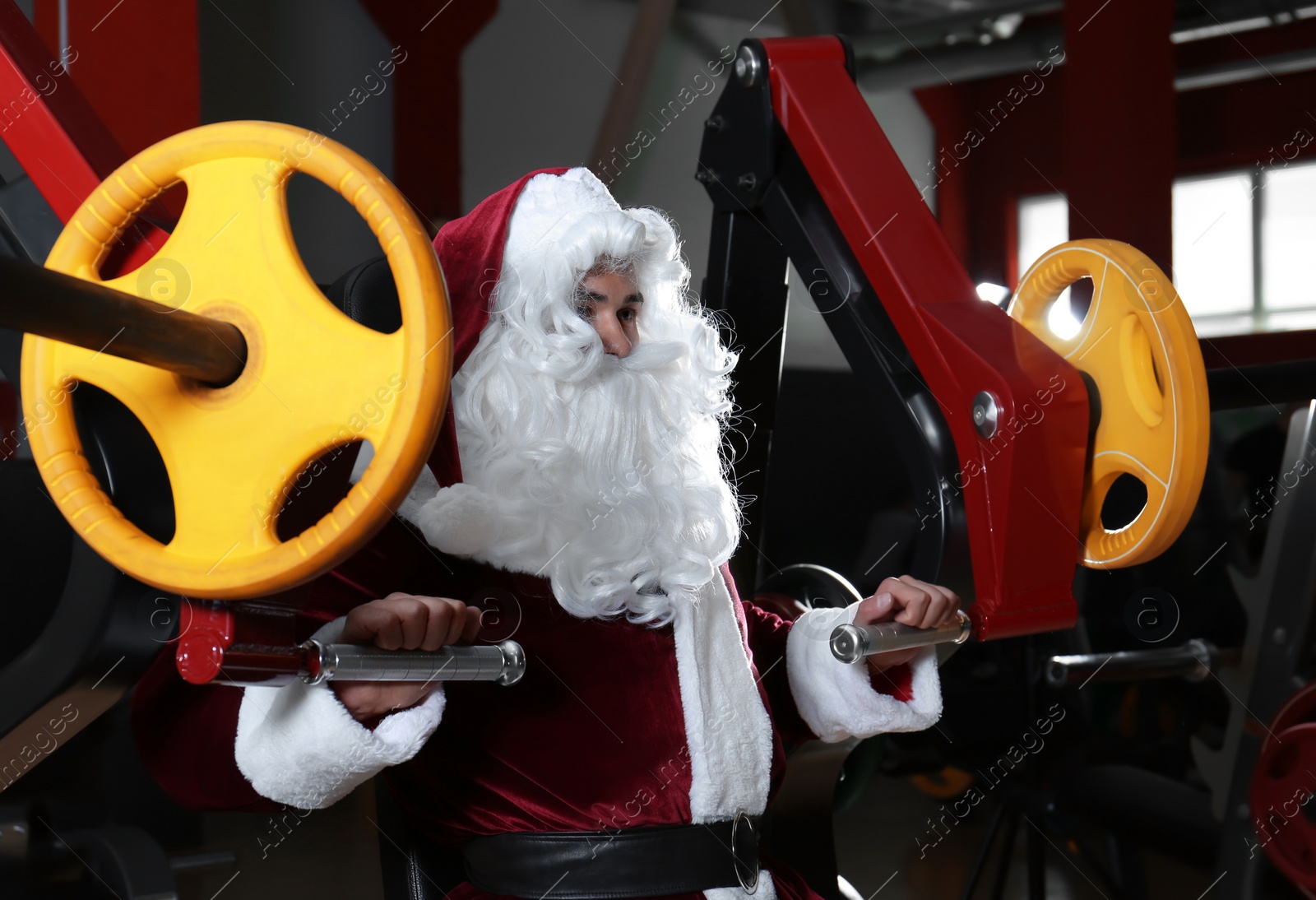 Photo of Young Santa Claus training in modern gym