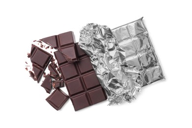 Photo of Pieces of delicious dark chocolate bar on white background, top view