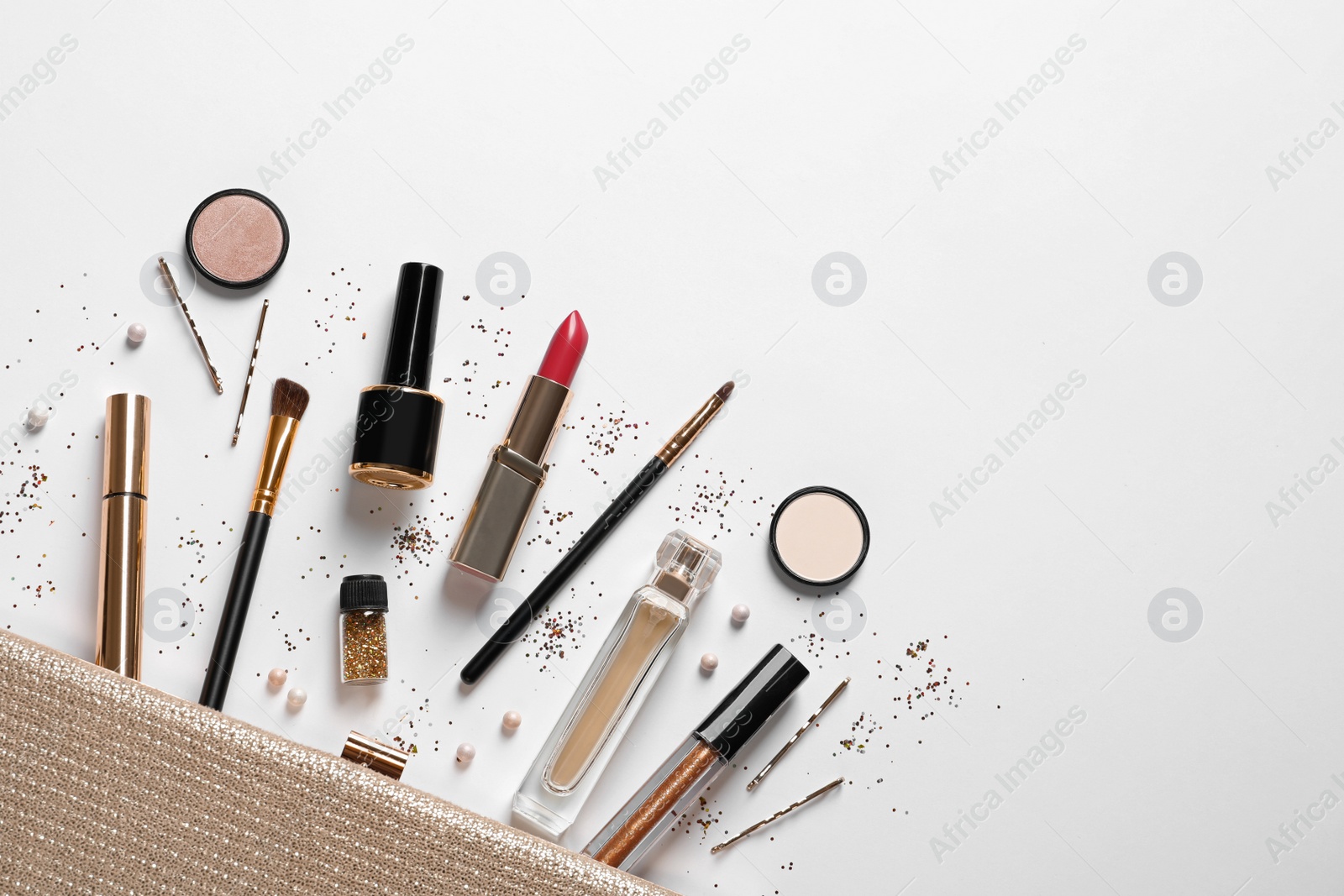 Photo of Cosmetic bag and different luxury makeup products on white background, top view