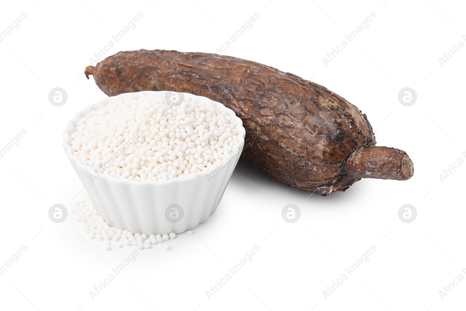 Photo of Tapioca pearls in bowl and cassava root isolated on white