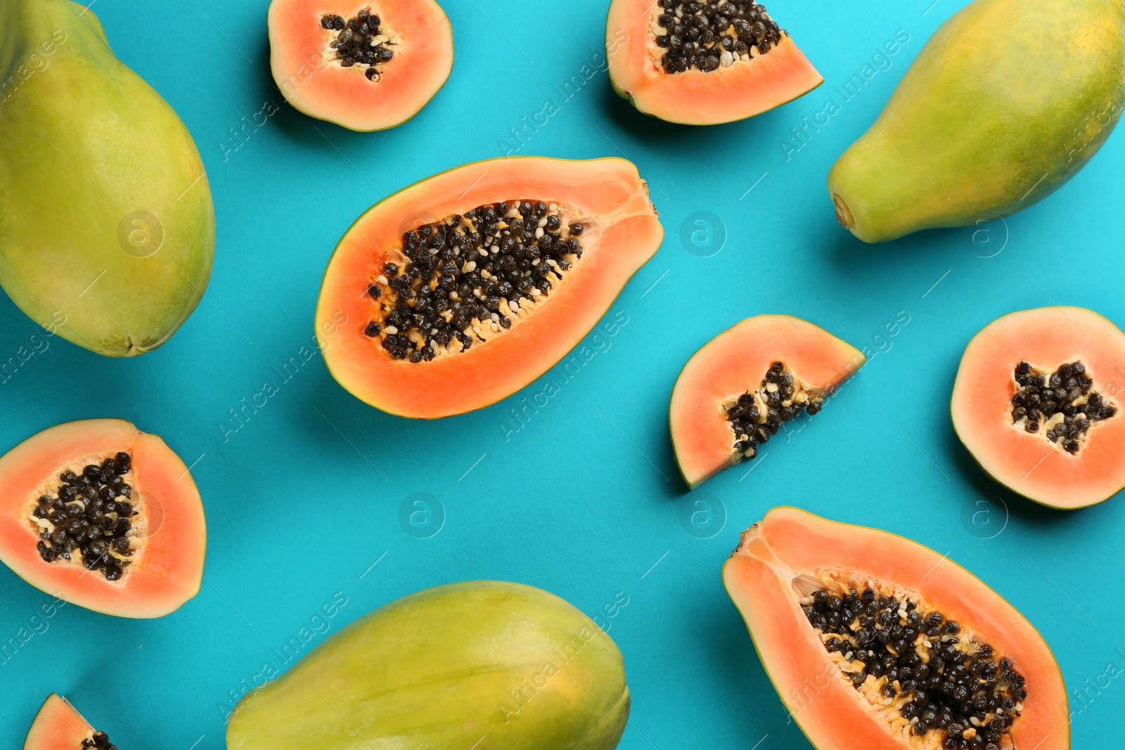 Photo of Fresh ripe papaya fruits on blue background, flat lay